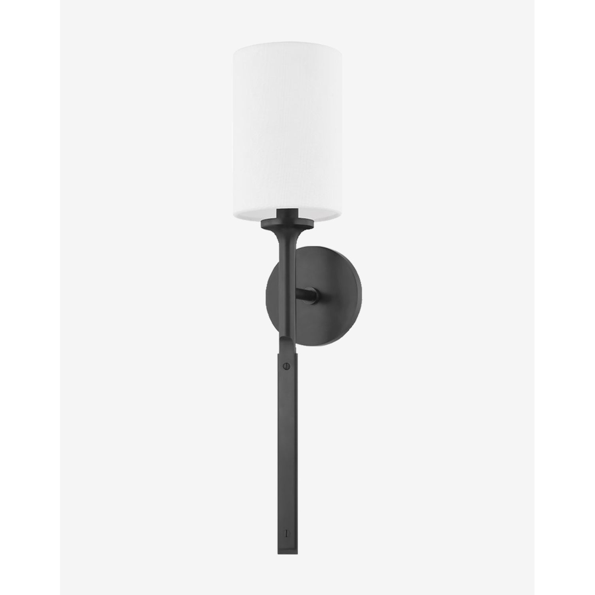 Brewster Sconce matte black wall light mounted on interior wall with warm glow