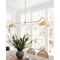 Aldorno linear chandelier with brass finish and round shallow shades.