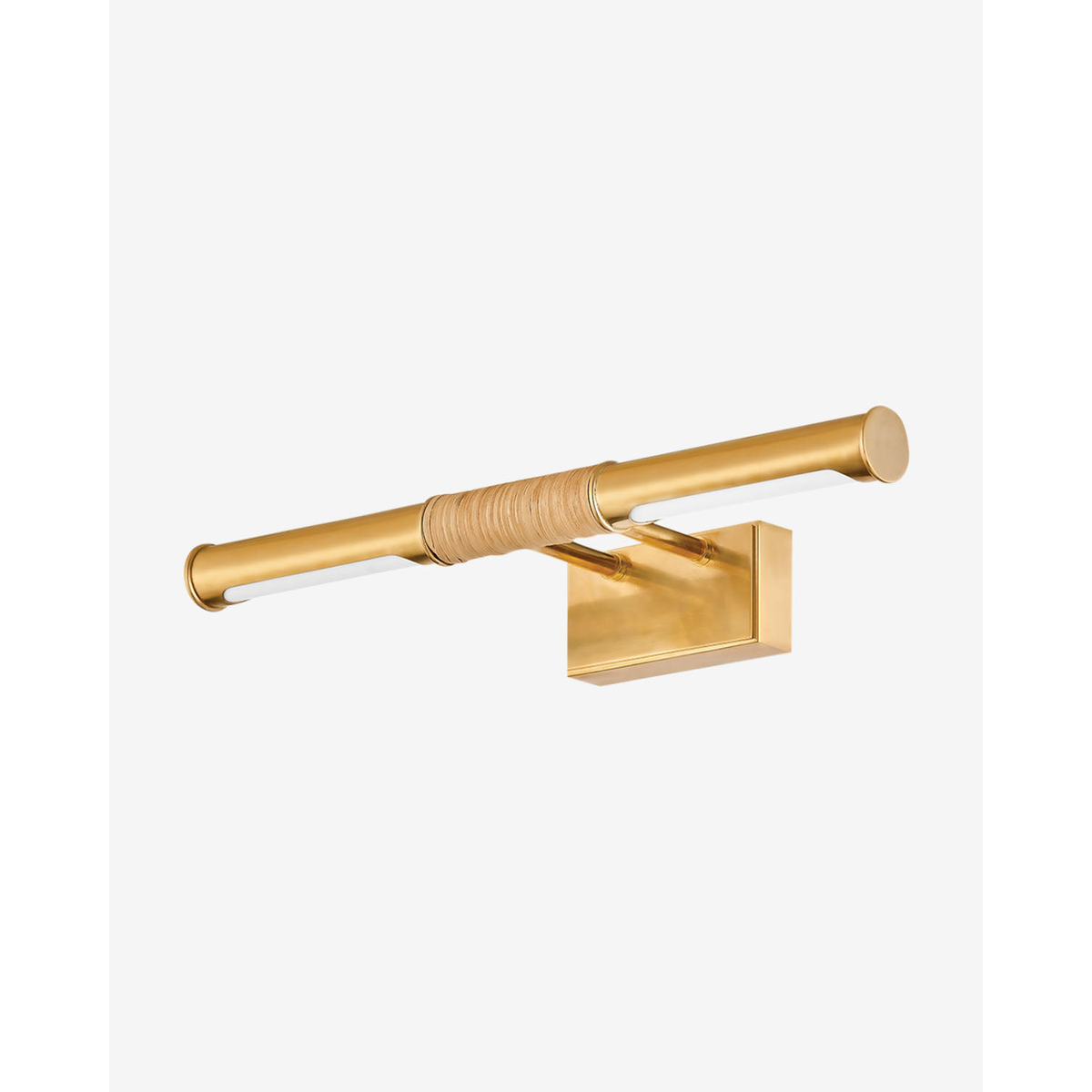 Hallstead Picture Light in aged brass luxuriously illuminating framed artwork in a curated interior.