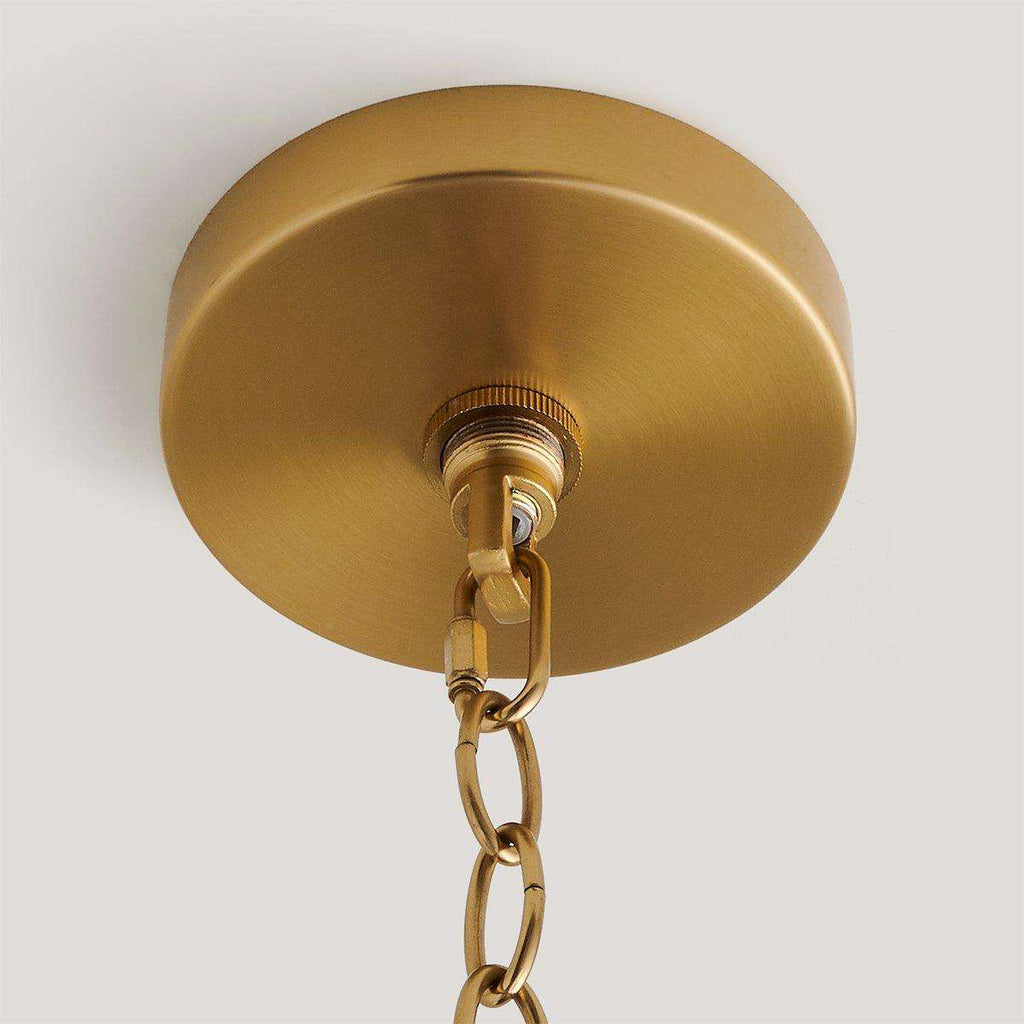 handwoven rattan pendant light with aged brass hardware