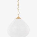 Semilla Pendant woven organic seed-form hanging light casting warm ambient glow over dining table