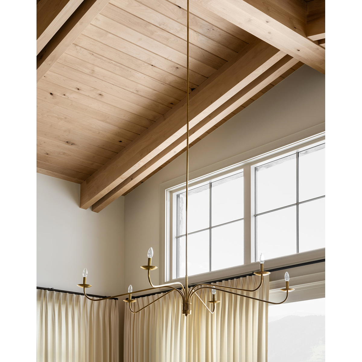 Philomena chandelier with sweeping arms and candle lights