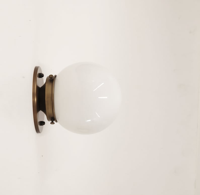 globe shade brass sconce