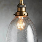 industrial cloche pendant in antiqued brass