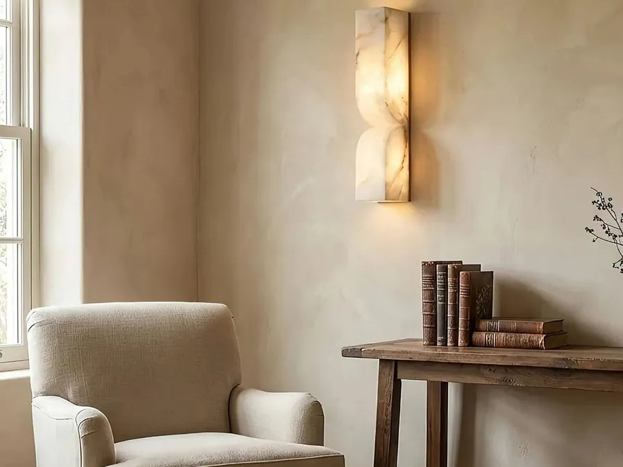 Alabaster wall sconce beside a fireplace