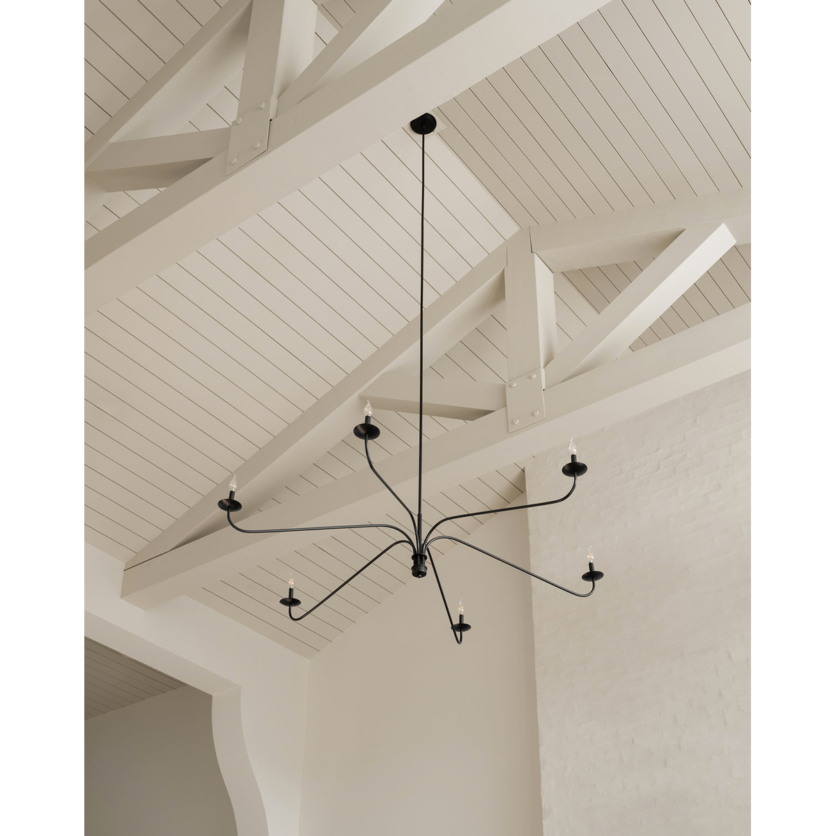 Philomena chandelier with sweeping arms and candle lights