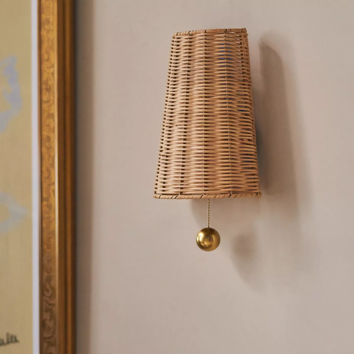 Naida Hand-Woven Rattan Wall Sconce with Aged Brass Pull