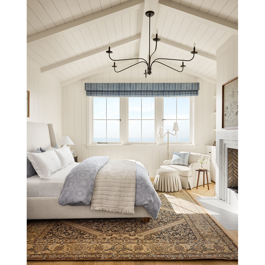 Philomena chandelier light fixture with sweeping arms and candle-shaped lights.