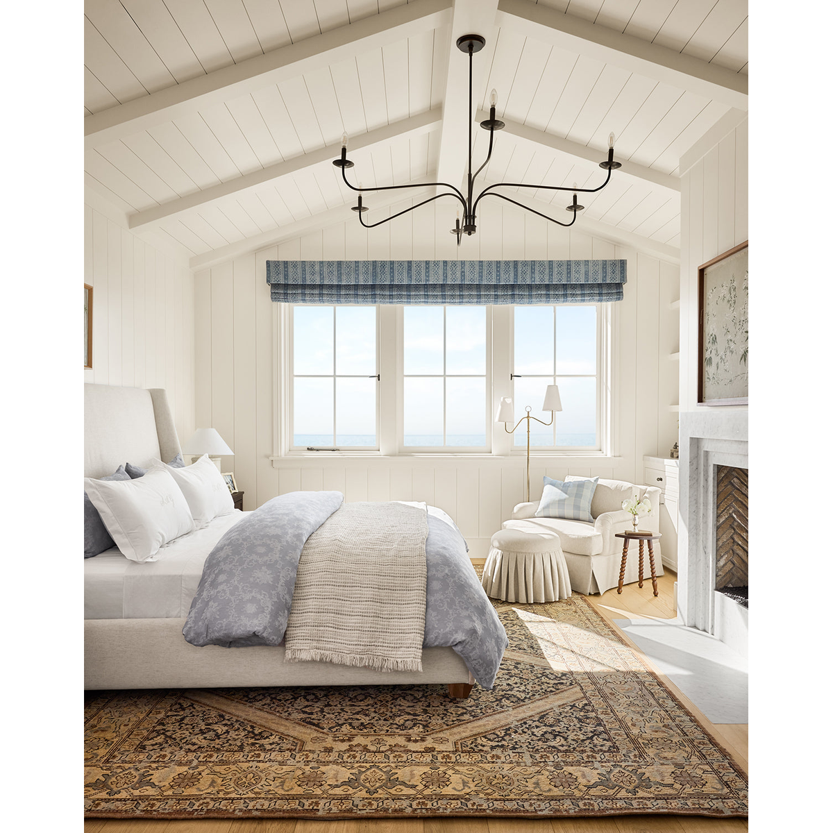 Philomena chandelier light fixture with sweeping arms and candle-shaped lights.